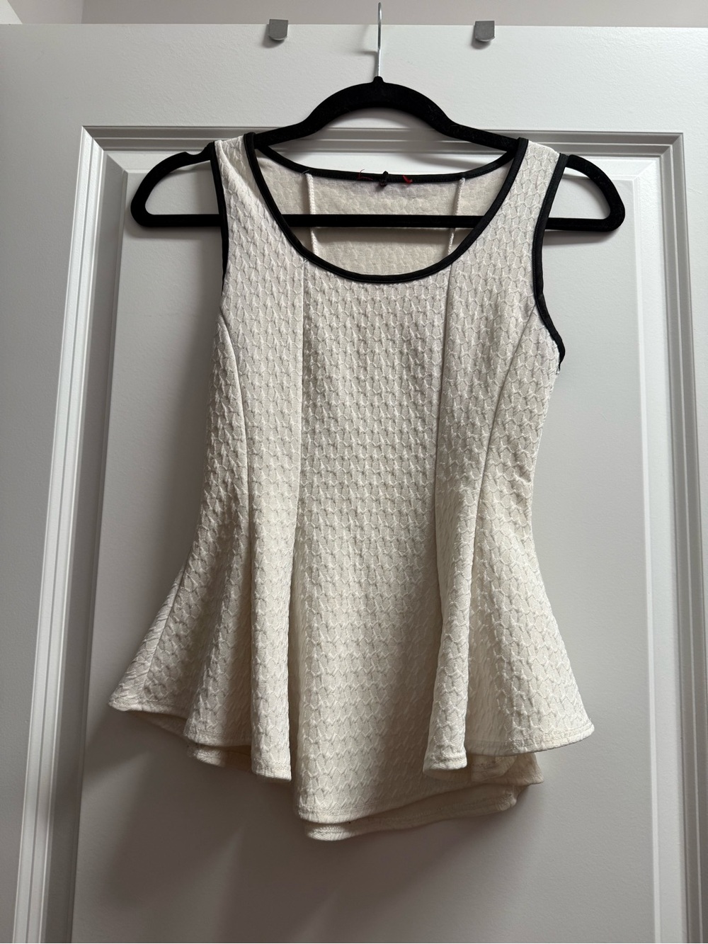 White peplum top with black trim
